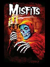 Old Misfits picture saying 'Misfits' and featuring a skeleton wearing orange robes and holding a candle